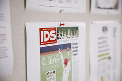 An Indiana Daily Student newspaper pinned to a wall.